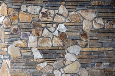 Arka plan ya da doku olarak taş duvar. Bir taş duvarın parçası, arkaplan veya doku için
