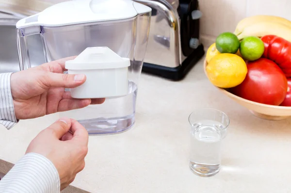 Man changes filter in the filter jug — Stock Photo, Image