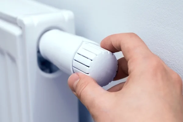 Man's hand adjusting radiator temperature. — Stock Photo, Image