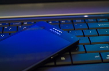 The Samsung Galaxy A5 laying on laptop keyboard