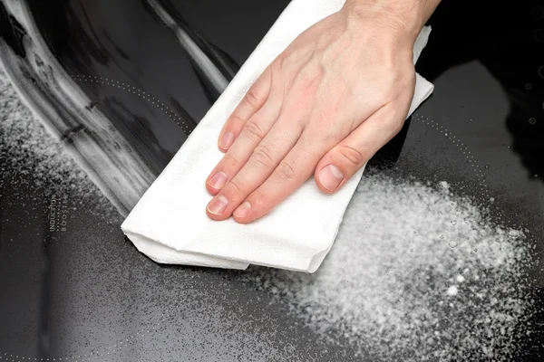 Cleaning the induction hob with special liquid — Stock Photo, Image