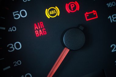 Airbag warning light. Car dashboard in closeup clipart
