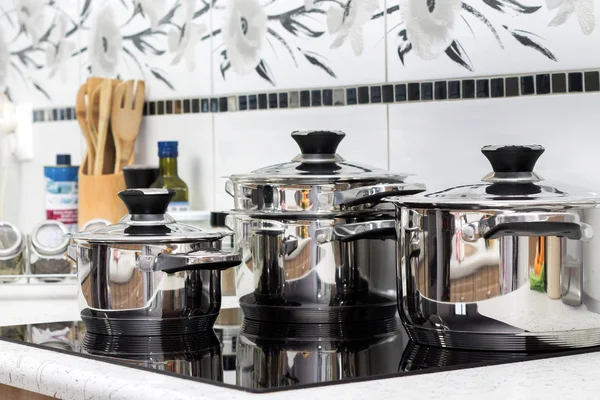 Modern induction cooker with the silver pots — Stock Photo, Image