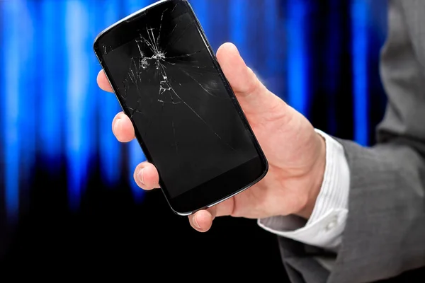 Businessman shows broken smartphone with crashed screen. — Stock Photo, Image