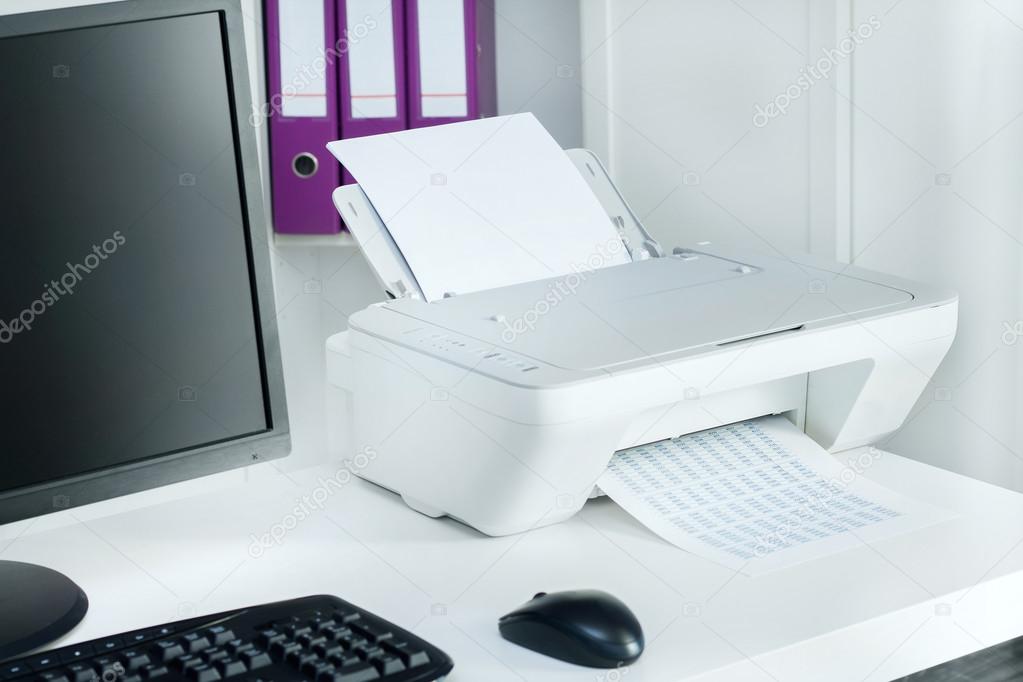 Composition of white printer and black computer in modern office