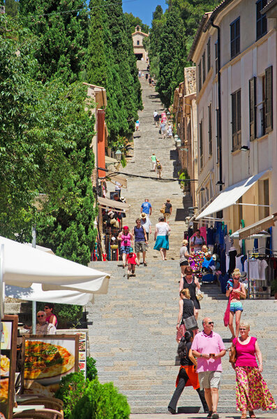 Mallorca, Balearic Islands, Spain, June 6, 2012: people coming down and climbing the 365 Calvary steps (Bottom Of Steps) in Pollenca, the big staircase of 365 steps leading to the little Church of Virgen de los Angeles