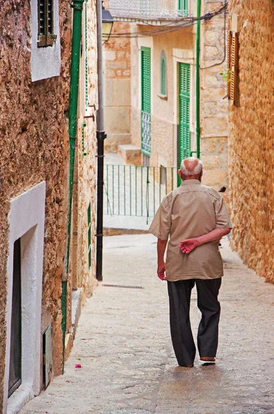 Mallorca, Balearic Islands, Spain: an old man walking in an alley of the old village of Fornalutx