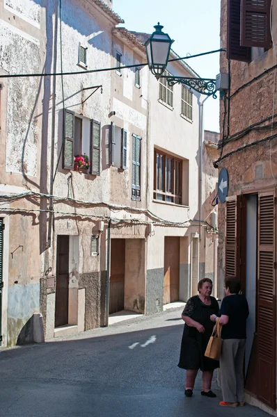 Mallorca, Balearic Islands, Spain: two old women talking in the streets of the old town of Arta