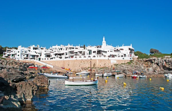 Menorca, Balearic Islands, Spain: Mediterranean Sea and the skyline of the white houses of the famous town of Binibeca Vell — Stock Photo, Image