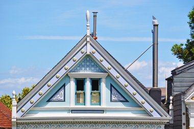 San Francisco, California, Usa: close up of the gable of one of the iconic Painted Ladies, a row of colorful Victorian houses at 710-720 Steiner Street across from Alamo Square park clipart