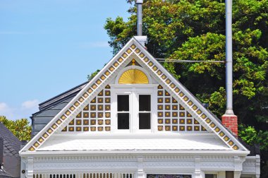 San Francisco, California, Usa: close up of the gable of one of the iconic Painted Ladies, a row of colorful Victorian houses at 710-720 Steiner Street across from Alamo Square park clipart