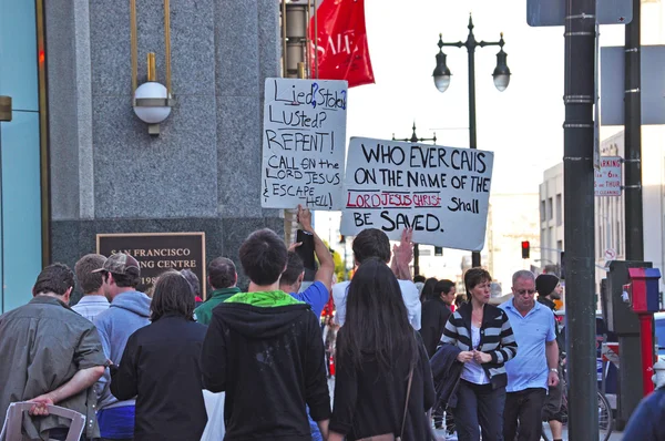 San Francisco, California: men demonstrate in the street holding signs with religious phrases