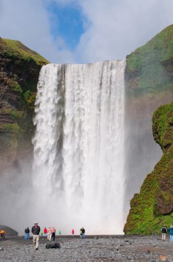 Iceland, Europe: a double rainbow and view of Skogafoss waterfall, famous tourist attraction situated on the Skoga River, at the cliffs of the former coastline, in the south of the island, with a width of 25 metres and a drop of 60 metres