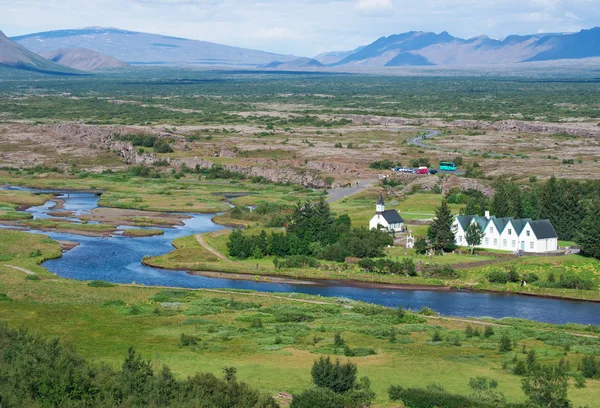 Thingvellir National Park, Iceland, Europe: Thingvellir Church and Thingvallabaer farmhouse, built in 1930 for the 1000 anniversary of the Althing (national Parliament 930 AD-1798) now used as park warden office and prime minister summer house — стоковое фото