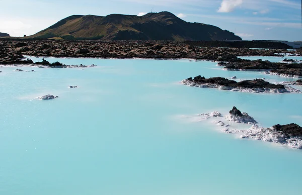 Iceland, Europe: silica water and black rocks at the Blue Lagoon, a famous geothermal spa in a lava field in Grindavik, Reykjanes Peninsula, one of the most visited attractions in Iceland