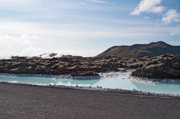 Iceland, Europe: silica water and black rocks at the Blue Lagoon, a famous geothermal spa in a lava field in Grindavik, Reykjanes Peninsula, one of the most visited attractions in Iceland