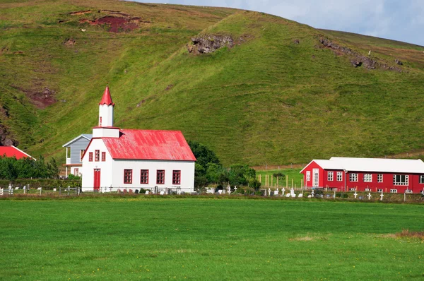 Iceland, Europe: view of Reyniskirkja, the little church located high on a hill in the town of Vik i Myrdal, the southernmost village of the island along the Ring Road — Stock Photo, Image