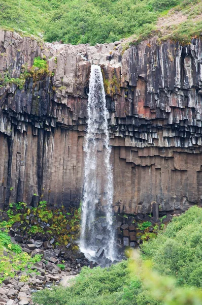 Iceland, Europe: aerial view of the Svartifoss waterfall, Black Falls, a famous tourist attraction in Skaftafell, within the Vatnajokull National Park, surrounded by dark lava columns Stock Photo