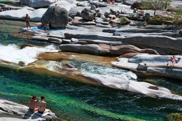 Lavertezzo, Switzerland: people seated on the rocks in the canyon of the Verzasca River