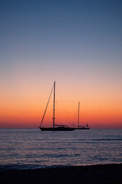 Formentera, Îles Baléares, Espagne : coucher de soleil à couper le souffle et voiliers sur la plage de Ses Illetes, sur le côté ouest de la péninsule de Trucador, l'une des plages les plus célèbres de l'île — Photo