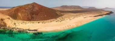 Aerial view of the Playa de las Conchas and mountain Bermeja, La Graciosa island in Lanzarote, Canary island. Spain. Ocean view and sand beach  clipart