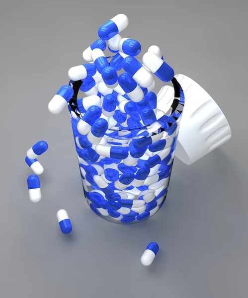 Blue and white pills in bottle — Stock Photo, Image