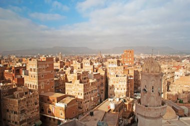Yemen, Middle East: aerial view of the skyline of the capital Sana'a, Unesco world heritage site, with its minarets, mosques and unique palaces and stone tower houses decorated with geometric patterns of fired bricks and white gypsum clipart