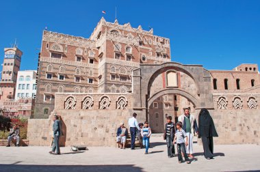 Yemen, Middle East: Yemeni people in front of the National Museum of Yemen, founded in 1971 in Dar al-Shukr (Palace of Gratefulness), one of the Yemeni Imam Palaces in Sana'a,  Unesco world heritage site  clipart