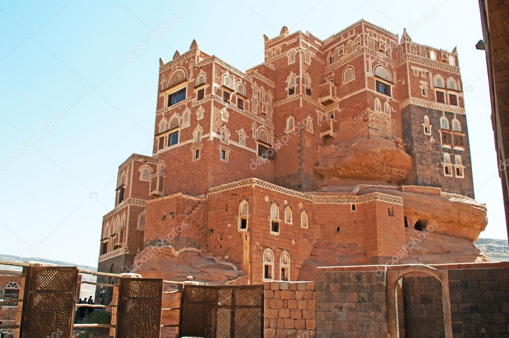 Yemen, Middle East: view of Dar al-Hajar (Stone House), the famous Rock Palace in Wadi Dhahr valley, a royal palace on top of a rock built as a summer retreat near the capital city of Sana'a, one of the most iconic Yemeni buildings 