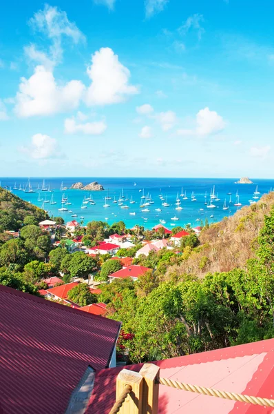 Saint Barthelemy (St Barth, St. Barths or St. Barts): aerial view of the bay and harbour of Gustavia with the red roofs of the main town and capital of the island seen from Corossol — Stock Photo, Image