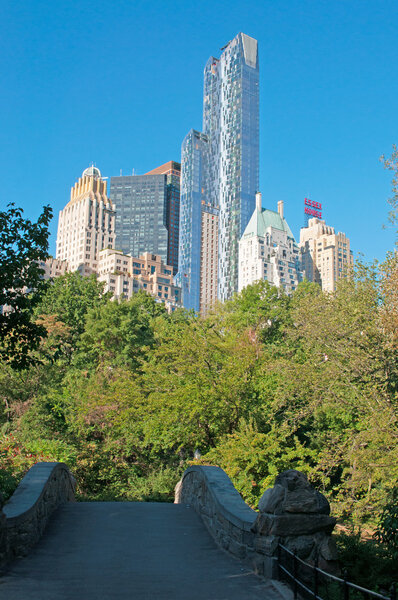 New York City, United States of America, Usa, September 16, 2014: the iconic skyline of the city seen from a stone bridge in Central Park, famous urban park in Manhattan between the Upper West Side and Upper East Side