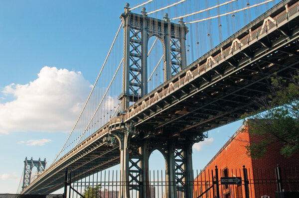 New York City, Usa, September 16, 2014: view of the Manhattan Bridge, a suspension bridge that crosses the East River, built by The Phoenix Bridge Company, designed by Leon Moisseiff and opened to traffic on December 31, 1909
