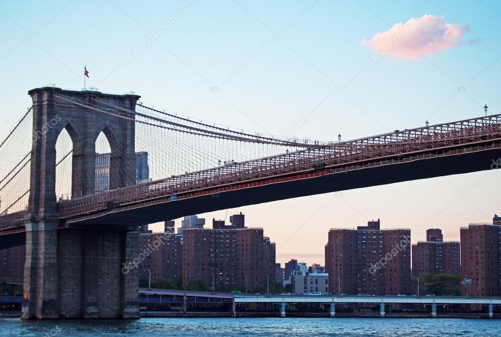 New York, Usa: panoramic view at sunset of the iconic Brooklyn Bridge, completed in 1883, connecting the boroughs of Manhattan and Brooklyn, spanning the East River