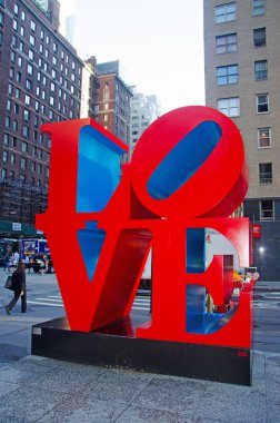 New York City: the skyline of the city with view of the Love sculpture, an iconic Pop Art work by american artist Robert Indiana at the intersection of Sixth Avenue and W 55th Street