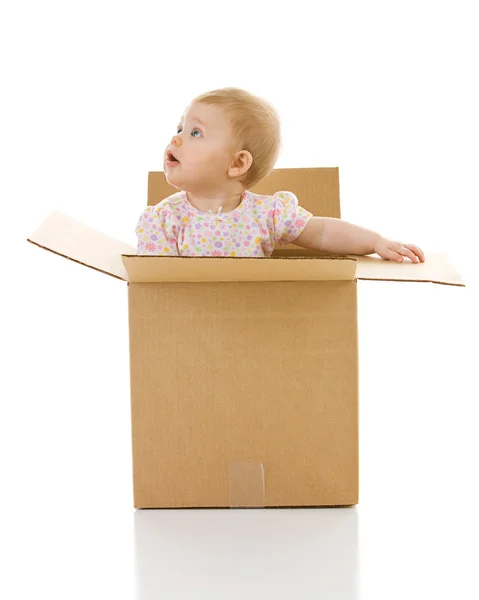 Bebê: menina levanta-se dentro da caixa — Fotografia de Stock