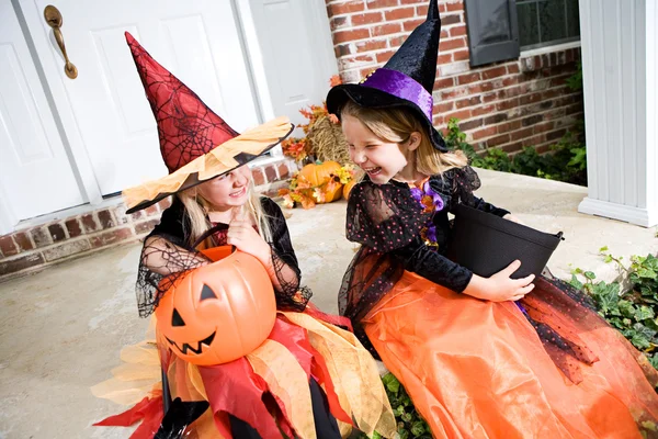 Halloween : Les filles s'assoient sur le porche avant avec une astuce ou traitent des bonbons — Photo