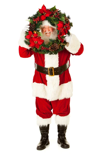 Санта-Клаус: взгляд сквозь рождественский венок — стоковое фото