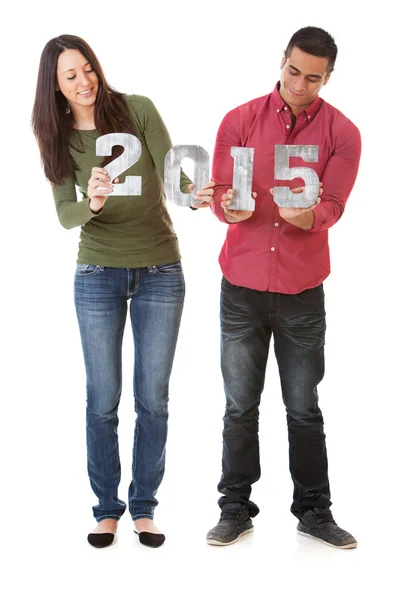 Nye: Młoda para trzymając numery na nowy rok 2015 — Zdjęcie stockowe
