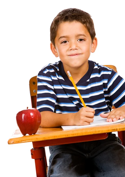 Estudante: menino fazendo lição de casa na mesa Imagens Royalty-Free