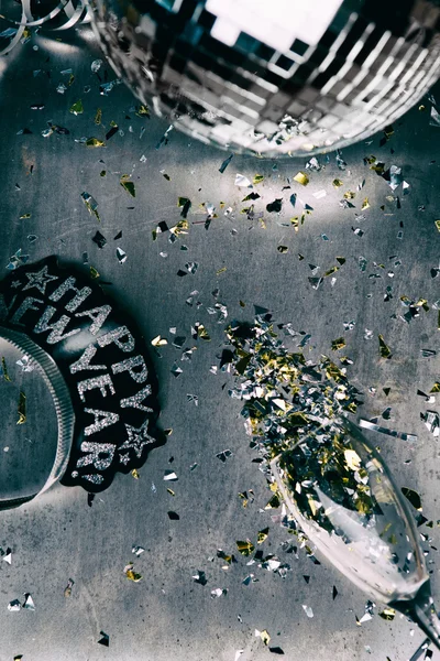 NYE: Disco Metal Background With Spilled Confetti From Glass — Stock Photo, Image