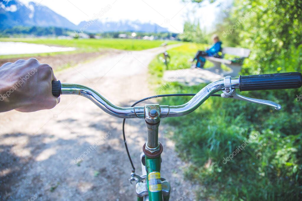 Closeup picture of a vintage bicycle handlebar and breaks outdoors, blurred background