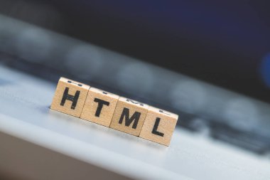 HTML harfli tahta küpler dizüstü bilgisayarın üzerinde duruyor..