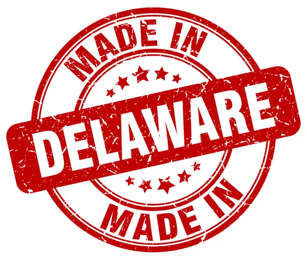 Made in Delaware red grunge round stamp — Stock Vector