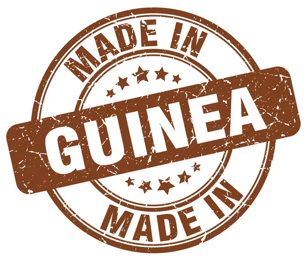 Зроблено в Гвінеї коричневий гранж круглі штамп — стоковий вектор