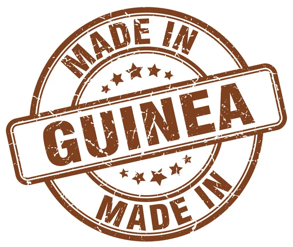 Wykonane w Gwinei brązowy nieczysty okrągły znaczek — Wektor stockowy