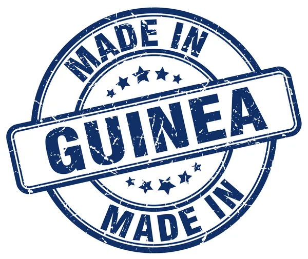 Wykonane w Gwinei niebieski nieczysty okrągły znaczek — Wektor stockowy
