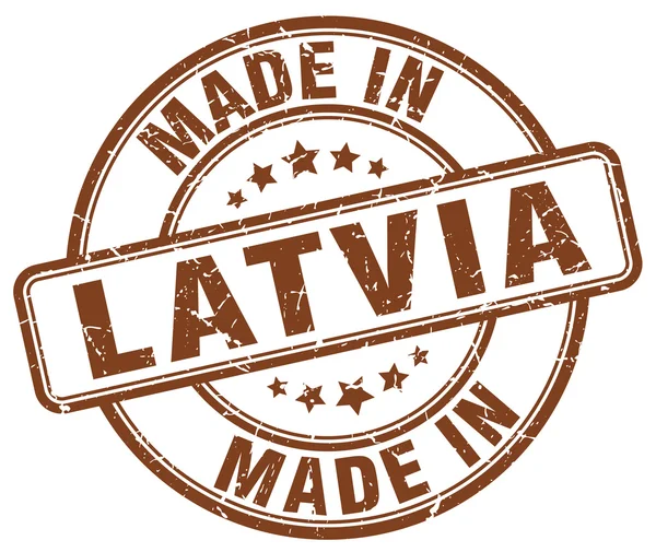 Зроблено в Латвії коричневий гранж круглі штамп — стоковий вектор