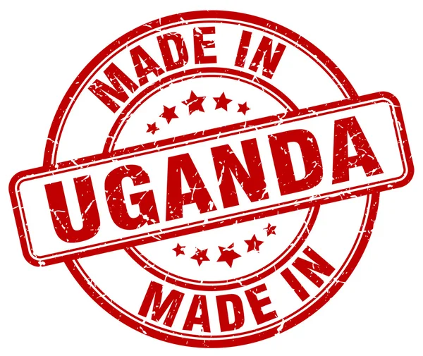 Made in Uganda red grunge round stamp — Stok Vektör