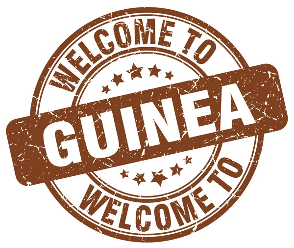 Benvenuto a Guinea marrone rotondo timbro vintage — Vettoriale Stock