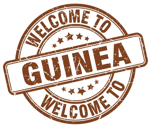 Benvenuto a Guinea marrone rotondo timbro vintage — Vettoriale Stock
